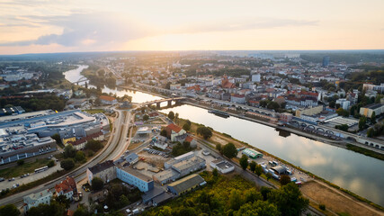 Fototapeta na wymiar In Gorzów Wielkopolski, a drone photo was taken on a sunny day featuring the River Warta, the Cathedral, and the city center