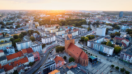 In Gorzów Wielkopolski, a drone photo was taken on a sunny day featuring the River Warta, the Cathedral, and the city center - obrazy, fototapety, plakaty