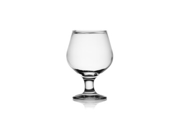 Empty cognac glass isolated, without glare. Reflection on the surface. Back light.	
