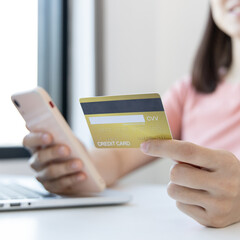 Businesswoman use mobile phones to register for security Online with a credit card to buy products online through application, Online shopping or Internet technology concept.
