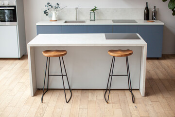 Modern kitchen interior in scandinavian style and gray tones. Kitchen island and bar stool.