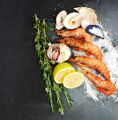Now that looks delicious. High angle studio shot of delicious shrimps and herbs on a table.