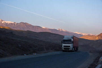truck with a trailer on the road in the mountains