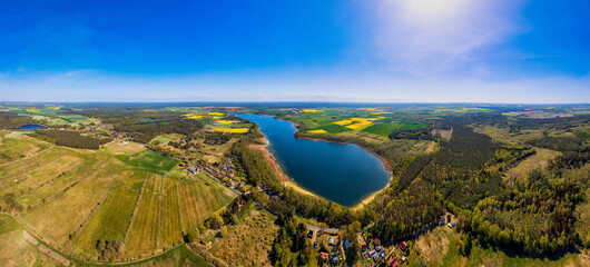 This stunning drone panorama captures a lake in Poland's Lubuskie Voivodeship on a bright and sunny...