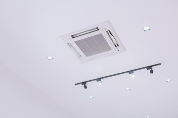 Ceiling type 4 directions air vent system air conditioner unit in a modern office building and...