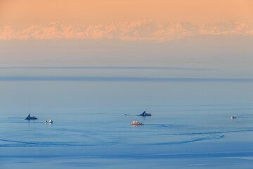 Naklejka premium fishing in the black sea, the Caucasus mountains in the background