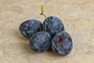 Ripe plum heap over background