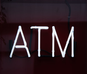 Obraz premium white neon atm sign on a shop wall