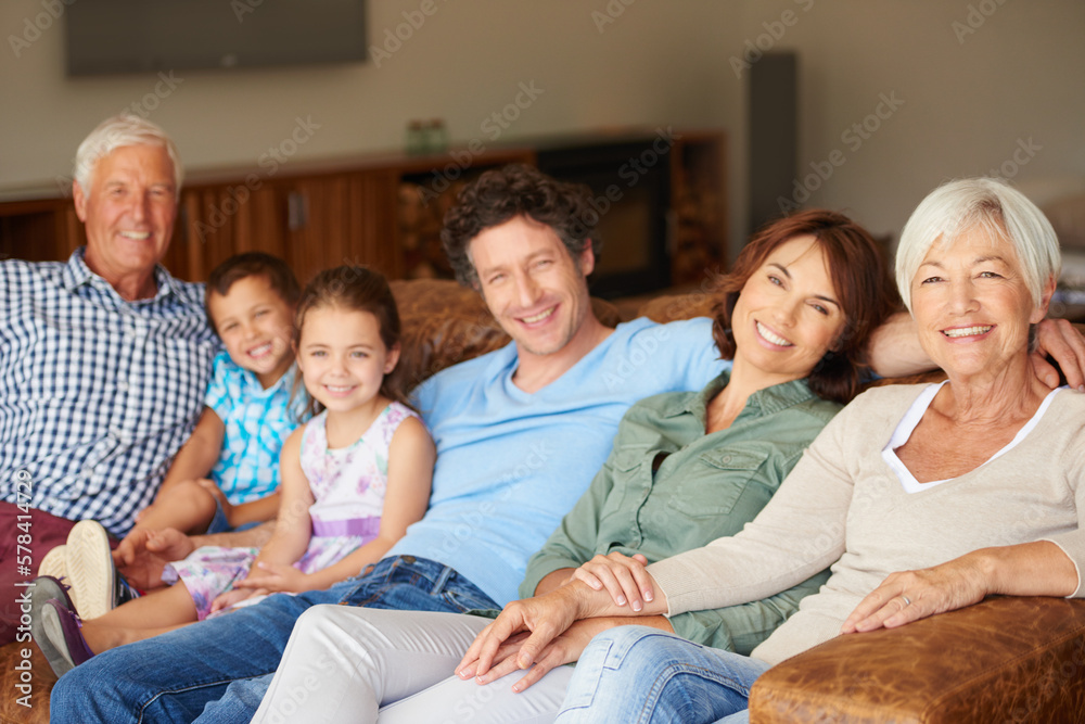 Canvas Prints Carefree time as one big, happy family. a happy multi-generational family sitting together on a sofa.