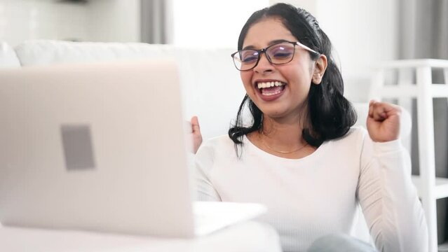 Portrait of amazed lucky indian woman extremely happy after read email message at computer at home Excited girl looking at screen won pleased rejoices received great news on laptop Success Triumph