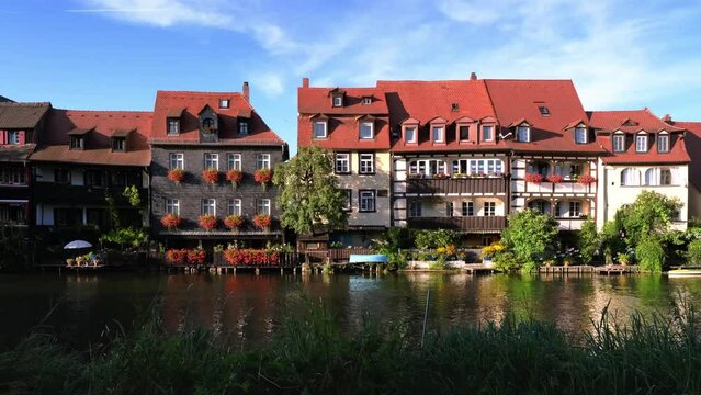 Sunny summer panorama of the romantic travel destination Little Venice in Bamberg, Germany. Lovely historical buildings in the famous old town. UNESCO World Heritage in northern Franconia, Bavaria. 4K