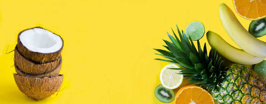 Tropical fruits on the yellow background. Banner. Copy space. Close-up.