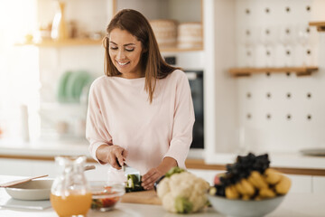 Obraz na płótnie Canvas Woman Preparing A Healthy Meal In The Kitchen