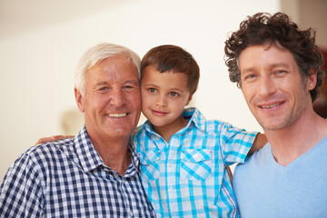 The guys are hanging out together today. Portrait of a little boy with his father and grandfather.