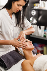 Woman Getting A Face Massage At The Beauty Salon