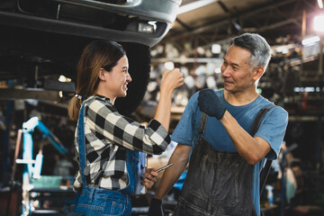 Concentrated technician and experienced car engine repair specialist, Confident Asian man auto mechanic working in automobile repair garage, industrial business of maintenance workshop service