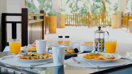 Fototapeta na wymiar Hotel breakfast at luxury restaurant with tropical atmosphere