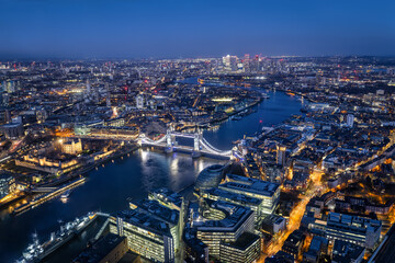 Fototapeta na wymiar Elevated view of the illuminated skyline of London with Tower Bridge and Thames River during night time, England