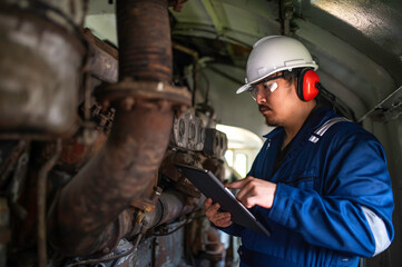 Engine engineer inspecting large machines in factory,Railway engine maintenance technician,engine repair mechanical manager