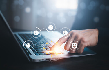 Businessman pressing smile on laptop keyboard customer service, evaluation concept,rating to service experience on online application, Customer review satisfaction feedback survey,Negative feedback