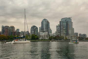 Fototapeta na wymiar Granville island marina and residential buildings in Vancouver downtown Canada