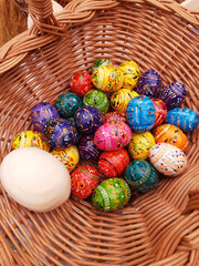 Easter wooden eggs in a basket close-up