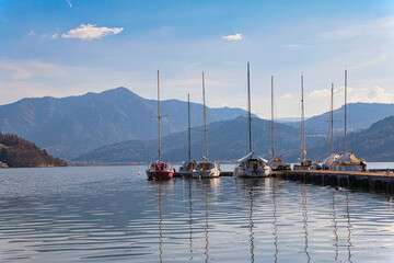 Sailboats moored on mountain lake in Italy