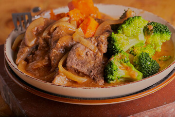 Liver and onions in gravy with sweet potatoes and broccoli.