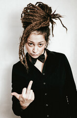 Girl with dreadlocks and bow tie showing middle finger up