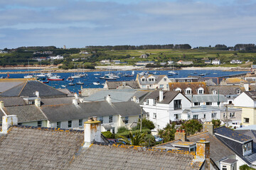 Isles of Scilly, United Kingdom -  view over the roofs of Hugh Town with sailboats anchoring in...