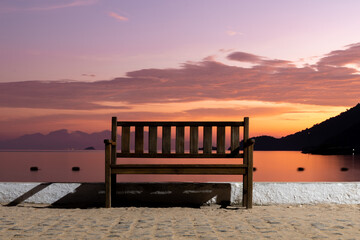 Fototapeta na wymiar Bench at the beach during sunrise 