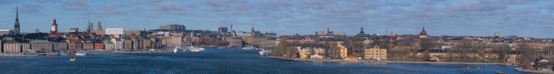Fototapeta na wymiar Panorama over the bay Strömmen, the old town, islands with museums, government houses, churches and boats, a sunny spring day in Stockholm