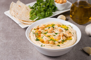 Hummus in a plate with chickpeas, smoked paprika, olive oil and pita. Vegetarian food.