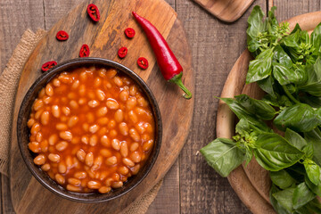 Chili beans on wooden table background. Kidney beans and vegetable Mexican food. 