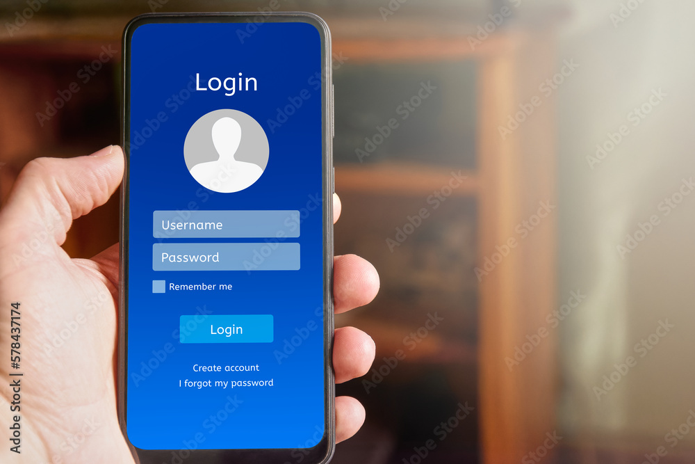 Wall mural man man holding mobile phone showing login interface on mobile phone screen, with username and passw