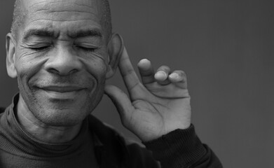 suffering from deafness and hearing loss on grey background with people stock photo