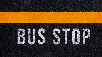 Bus stop text written and yellow line on the road in middle of the asphalt road, Bus stop word on...