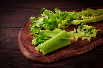 fresh bunch of celery, top view, no people, on a dark background,
