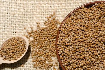 Coriander grains in a ceramic bowl.