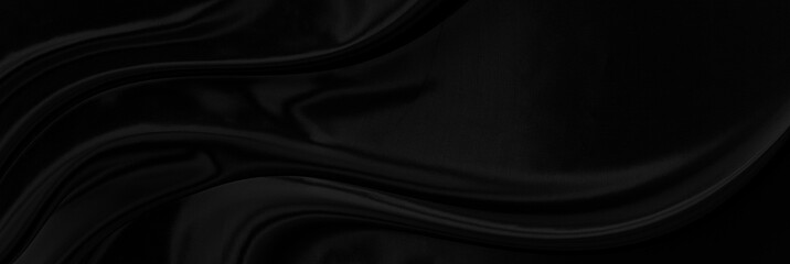 Black gray satin dark fabric texture luxurious shiny that is abstract silk cloth panorama background with patterns soft waves blur beautiful.