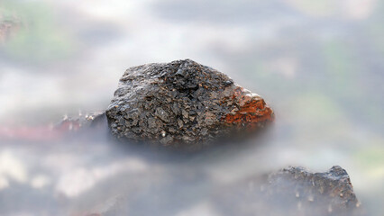 a rock wrapped in a mist effect