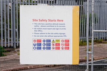 Construction site health and safety message rules sign board signage on fence boundary