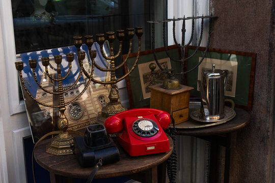 Hanukkah menorah, red phone, old camera and tea pot at display 