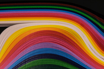 Abstract color wave curl rainbow strip paper on black background