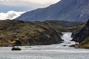 Huge waterfall drops into a lake at Torres del Paine National Park in Chile, Patagonia, South...