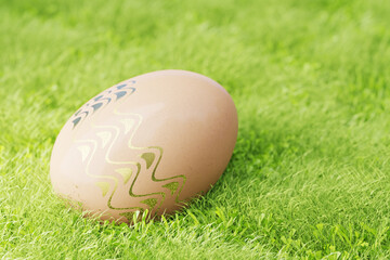 Brown Easter egg decorated with gilded patterns in green grass. 3d render.