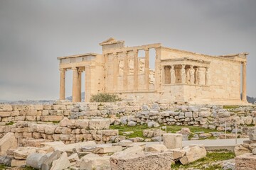 Fototapeta na wymiar The Erechtheion (Temple of Athena Polias) an ancient Greek Ionic temple-telesterion on the north side of the Acropolis during cloudy winter day
