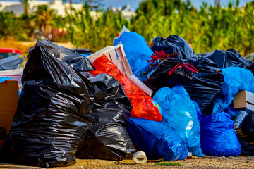 Huge pile of rubbish and waste in colorful plastic bags piled into the pile
