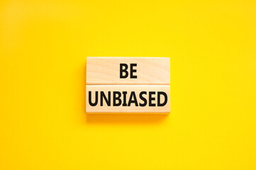 Be unbiased symbol. Concept words Be unbiased on wooden block. Beautiful yellow table yellow background. Business psychology be unbiased concept. Copy space.