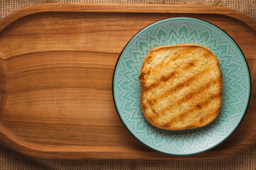 Delicious toast for breakfast on a beautiful plate on a wooden tray.